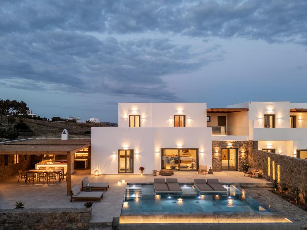 a house with a swimming pool in front of it at Vendema Residence Mykonos in Mikonos