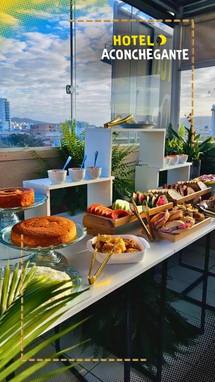 a buffet with many different types of food on a table at Hotel Aconchegante in Jequié