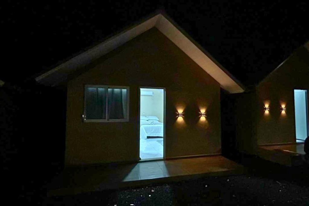 a small room with a bed in the dark at Chalés EduCarMo in Ametista do Sul