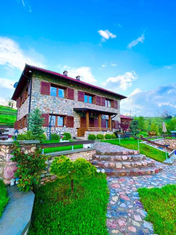 a house with a stone walkway in front of it at nKulle in Boge