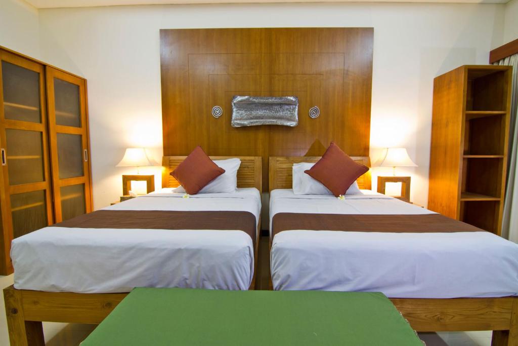 Postel nebo postele na pokoji v ubytování Maha Residence Guest House