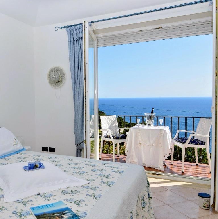 a bedroom with a view of the ocean at MARVELOUS CAPRI - Sea View Villa in Capri