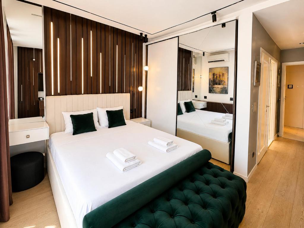 a bedroom with a large white bed and a mirror at BW LUX STUDIO-Belgrade Waterfront in Belgrade