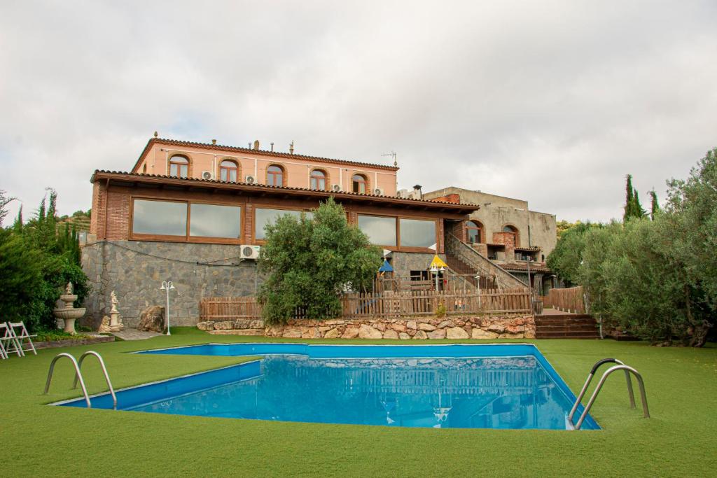 a house with a swimming pool in front of it at La Cassola del Priorat in Gratallops