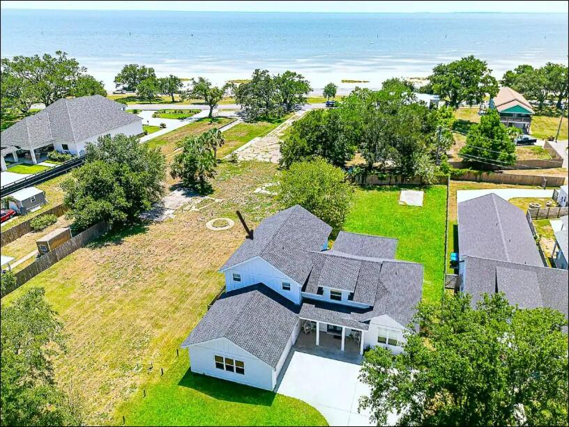 an aerial view of a house with the ocean at Luxe Dream Beach House in Gulfport