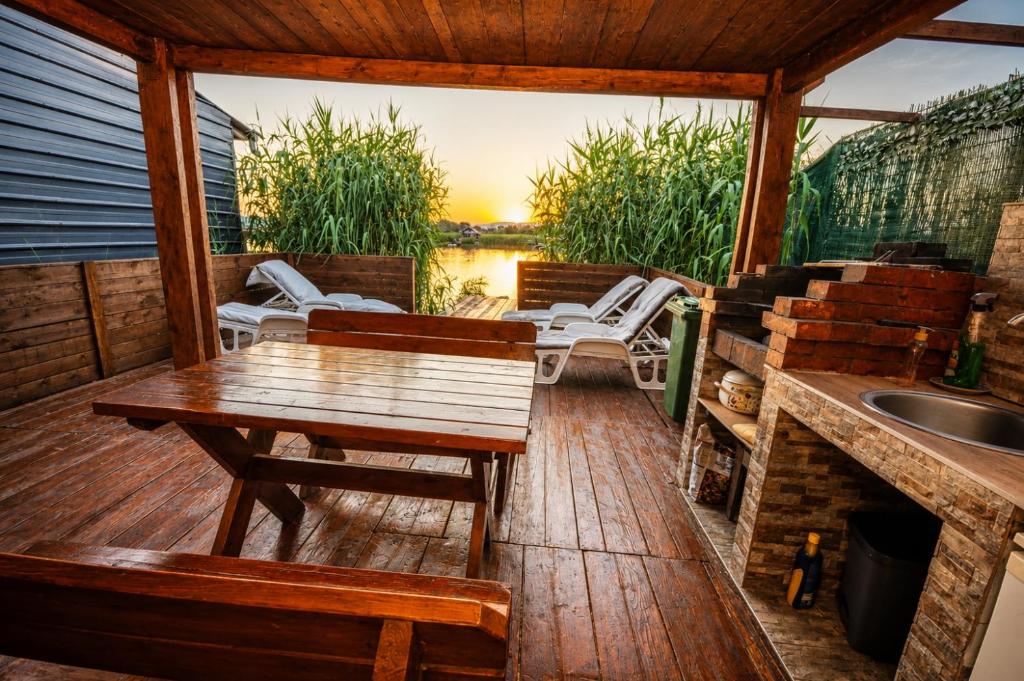 a deck with a table and chairs and a sink at SmallGrin Ada Bojana in Ulcinj