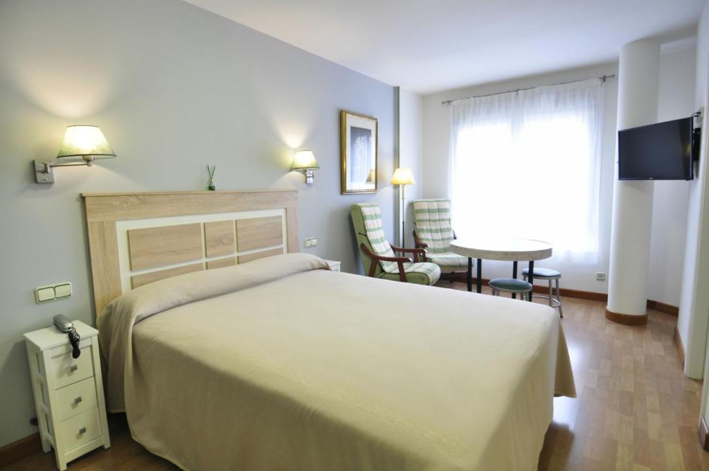 Posteľ alebo postele v izbe v ubytovaní Hotel Apartamentos Aralso