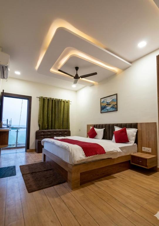 a bedroom with a bed and a ceiling fan at Hotel Padma Residency in Datia