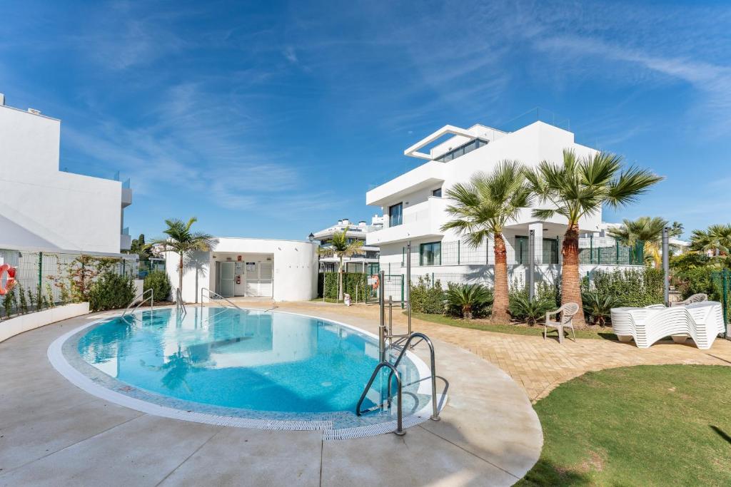a swimming pool in front of a house at Casa Miramar Oak 47 in Fuengirola