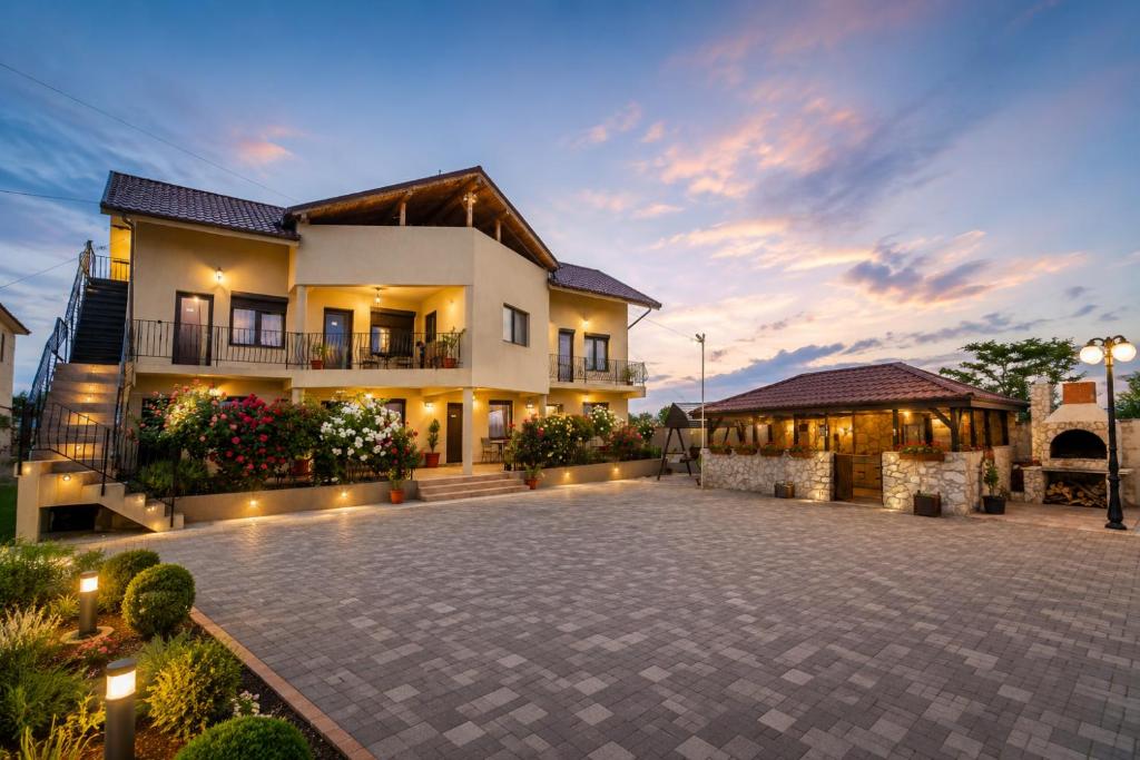 a house with a courtyard in front of it at Complex Route 66 in Vama Veche