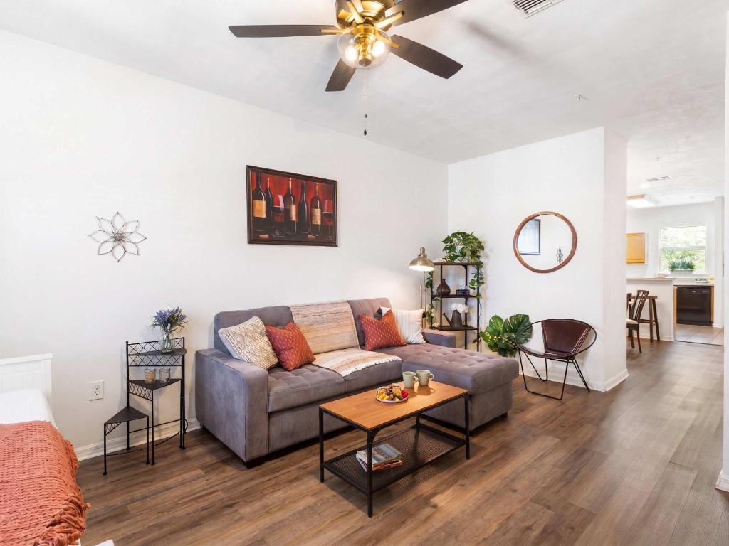 a living room with a couch and a ceiling fan at Convenient & Inviting - Fully-Equipped 2BD Condo in Gainesville
