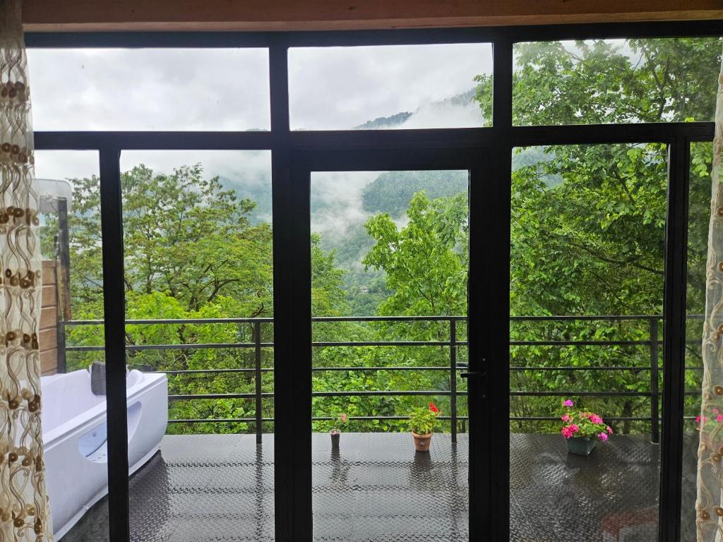 a view from a window of a bathroom with a tub at Machaxela Skyline in Tsʼkhemlisi