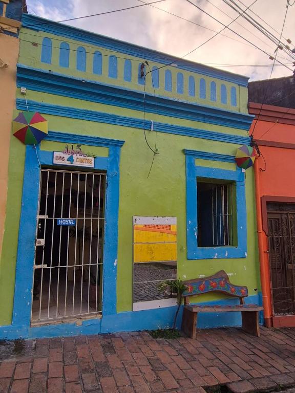 a colorful building with a gate in front of it at Hostel 4 Cantos in Olinda
