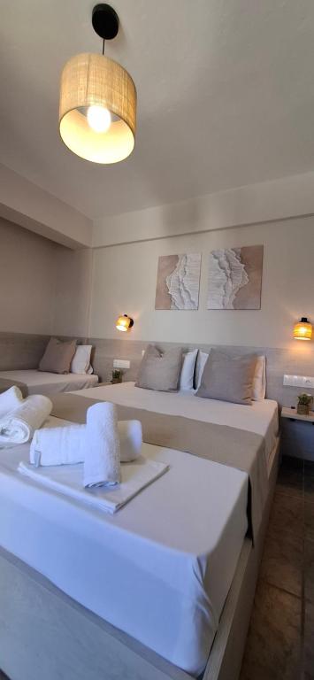 a room with two beds in a room with a light at House Kiriaki in Sarti