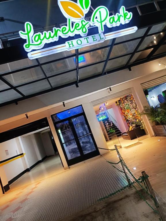 a restaurant with a sign on the front of a store at Hotel Laureles Park in Medellín