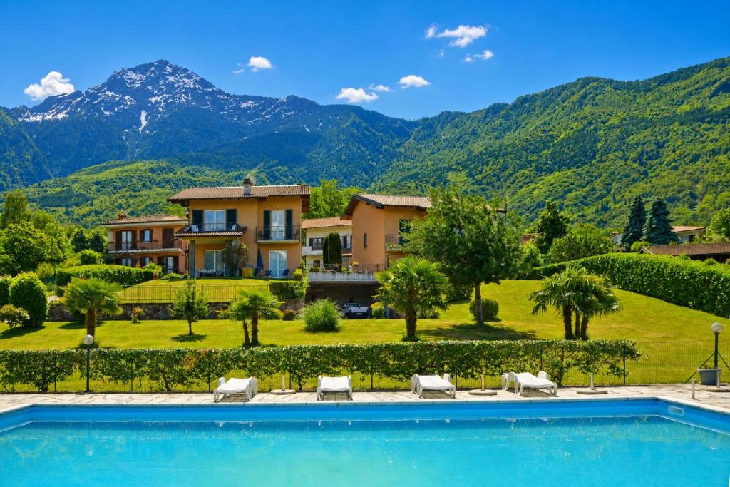 a villa with a swimming pool in front of a mountain at Calla in Colico