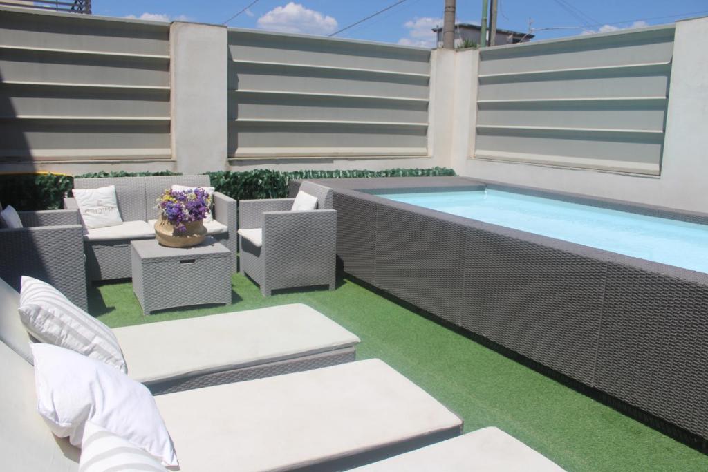 a patio with a pool and chairs and a swimming pool at Cridima Luxury - Villa Hera in Santa Maria La Carità