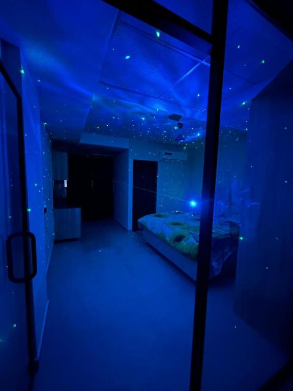 a room with a bed in a blue room at Cloud Eleven House in Kharar