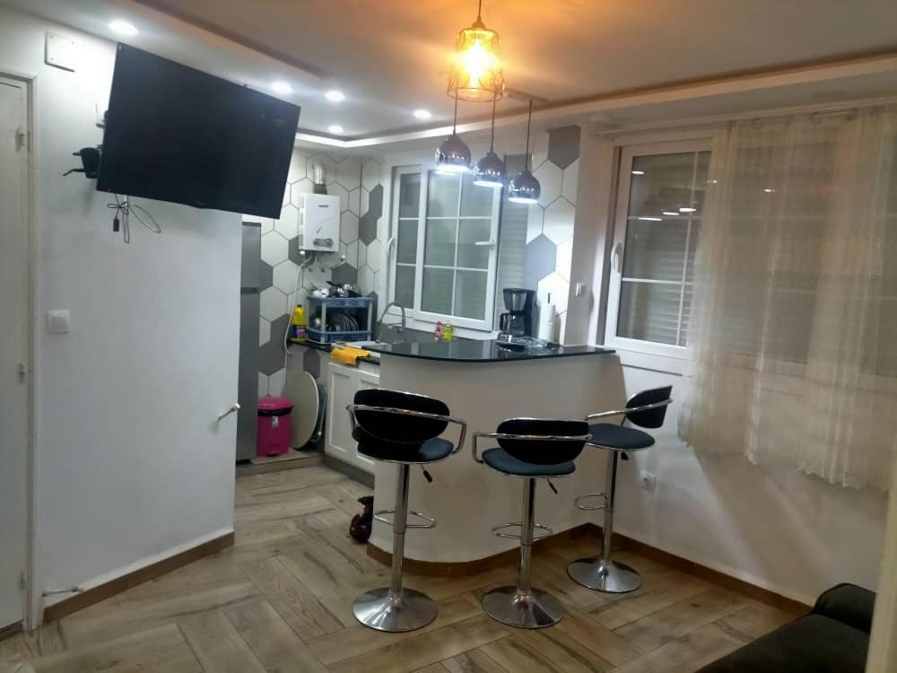 a kitchen with a counter and two bar stools at la perle de bougie in Bejaïa
