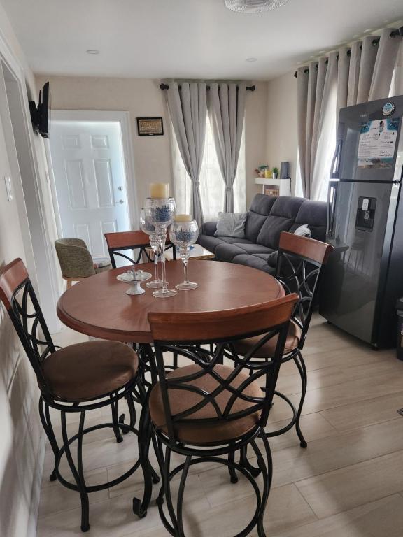 a living room with a table with wine glasses on it at Jaden's Guest House in Saint Michael
