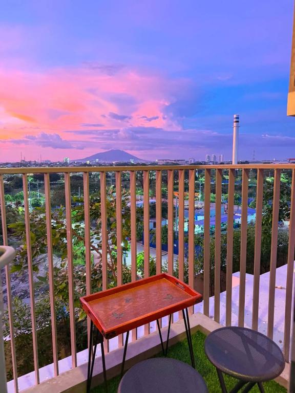 a table on a balcony with a view of the ocean at Ciao Vacanza Staycation in San Fernando