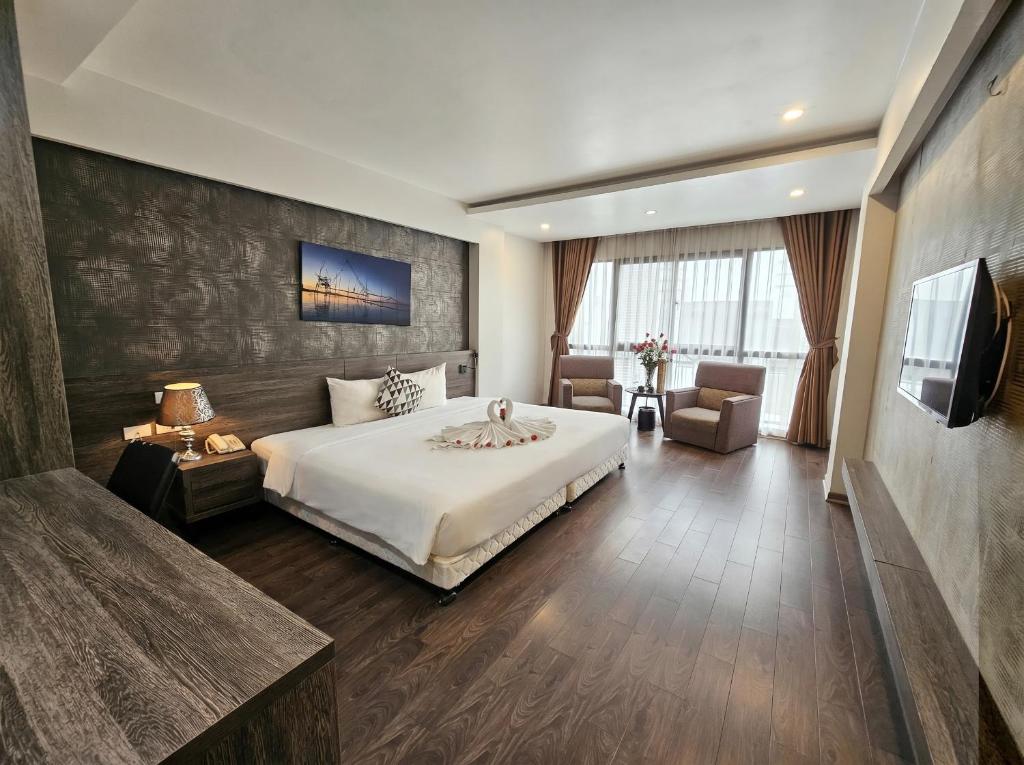 a hotel room with a bed and a television at Moon Luxury Hotel in Hanoi
