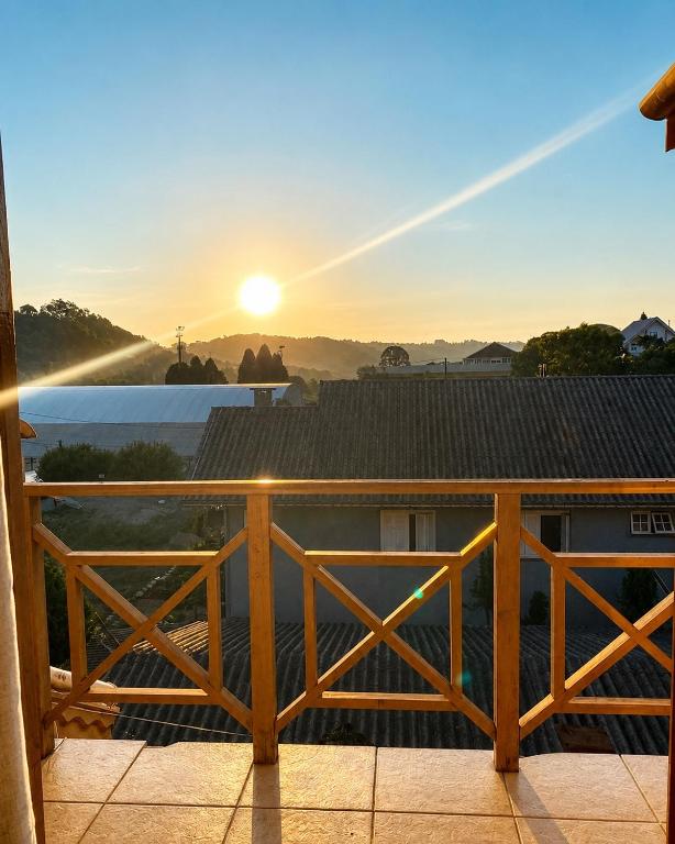 a view of the sunrise from the balcony of a house at Aptos Weber - Piratini in Gramado