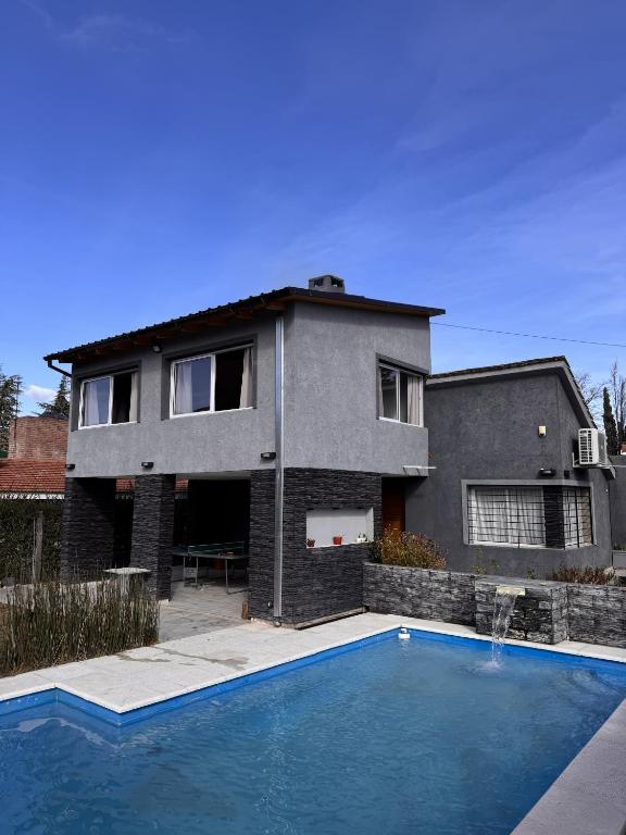 a house with a swimming pool in front of a house at Aurea san antonio in San Antonio de Arredondo