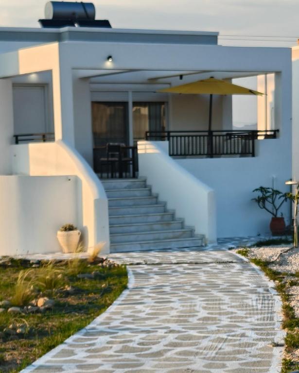 a house with a walkway in front of it at Villa Helia in Kos