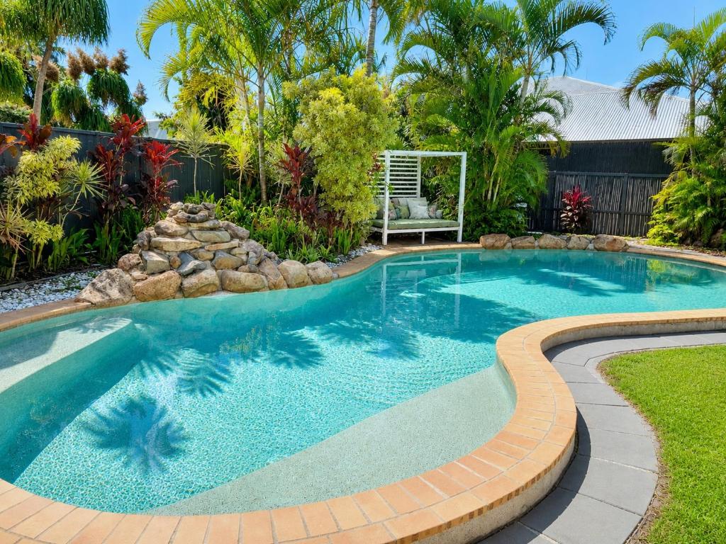 a swimming pool in a yard with a landscaping at Charming & Spacious 5 Bedroom Bayside House with Pool in Birkdale