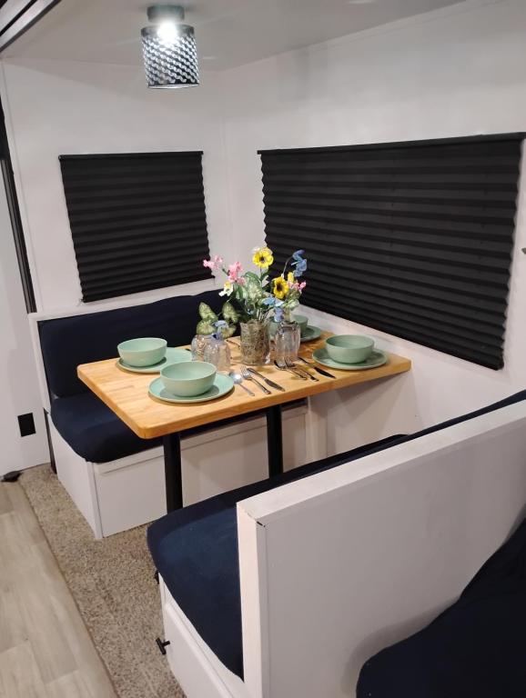 a dining room with a table with flowers on it at Camper Rental in Saint Helena Island