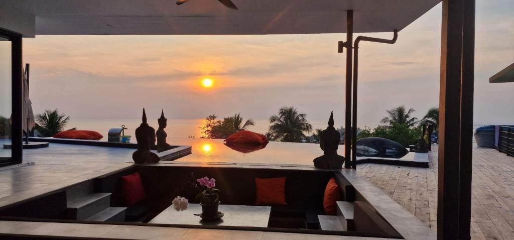 a villa with a view of the ocean at sunset at Luxury 5 bedroom villa Infinity pool Sea view in Haad Yao