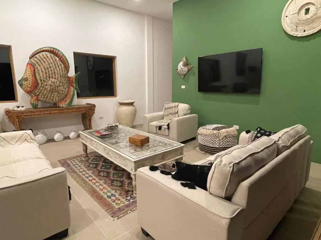 a living room with two couches and a table at Ubuntu Villa in Ko Phangan