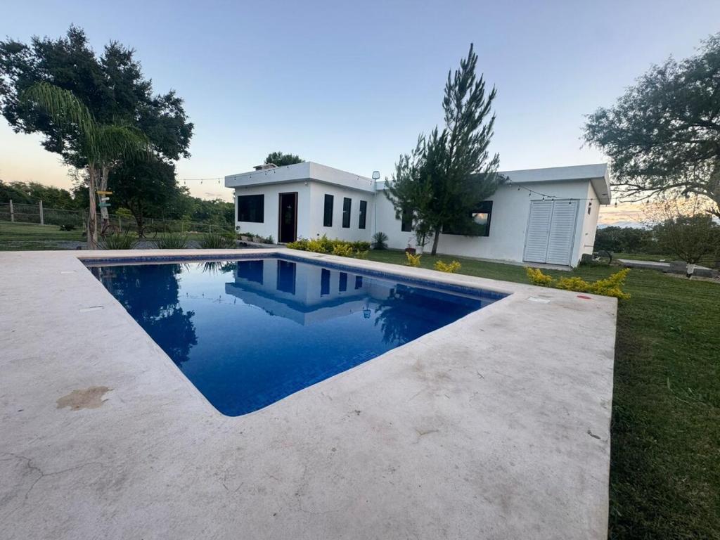 a swimming pool in front of a house at Quinta Bello Cielo in Montemorelos