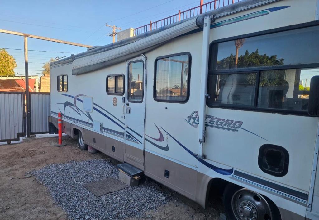 a white rv parked next to a building at Casa Rodante Tony 1 in San Felipe