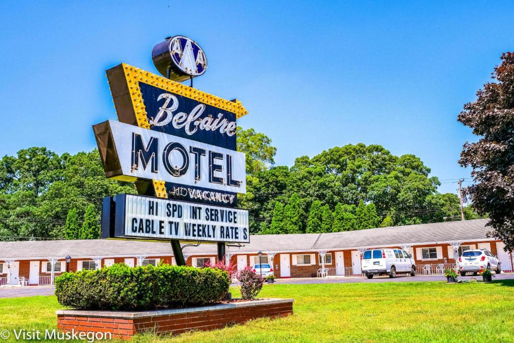 a sign for a motel in front of a building at Belaire Motel in Norton Shores