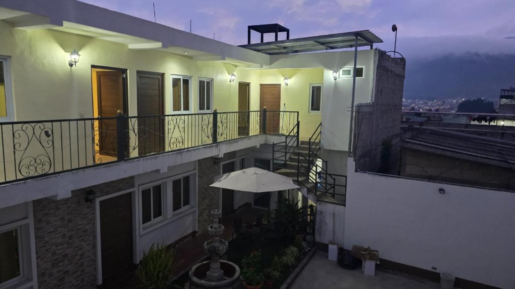 a balcony of a building with an umbrella at Villa Alissa in Quetzaltenango