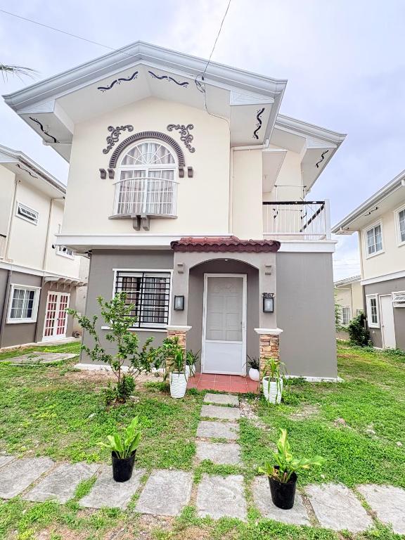 a large white house with a front yard at Casa Tranquila Panglao in Dauis