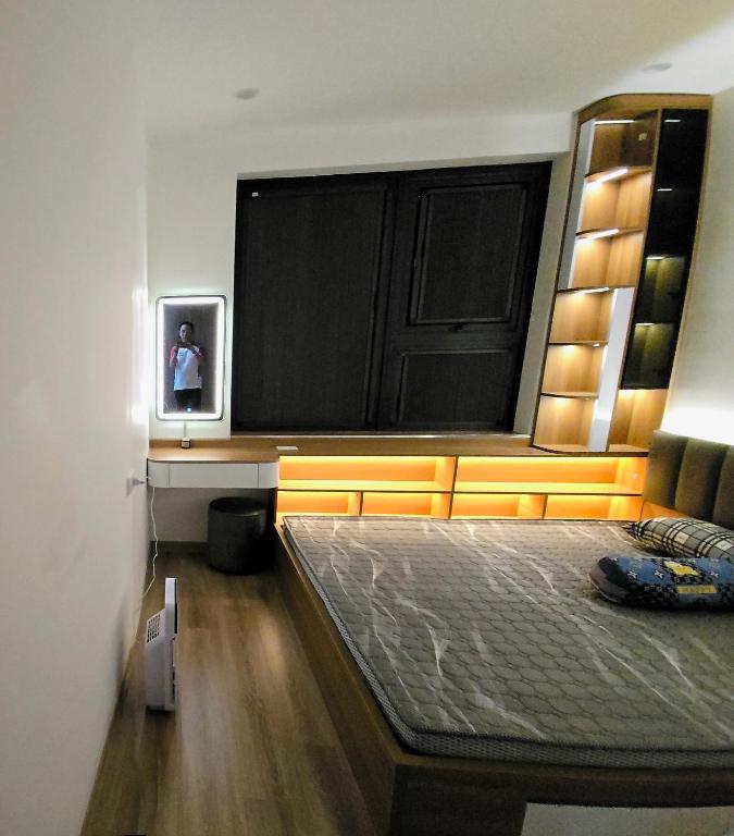 a bedroom with a large flat screen tv on the wall at Moon bay 384 in Ðoan Xá