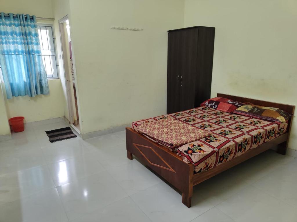 a bedroom with a bed in a room at Taj Palace in Covelong