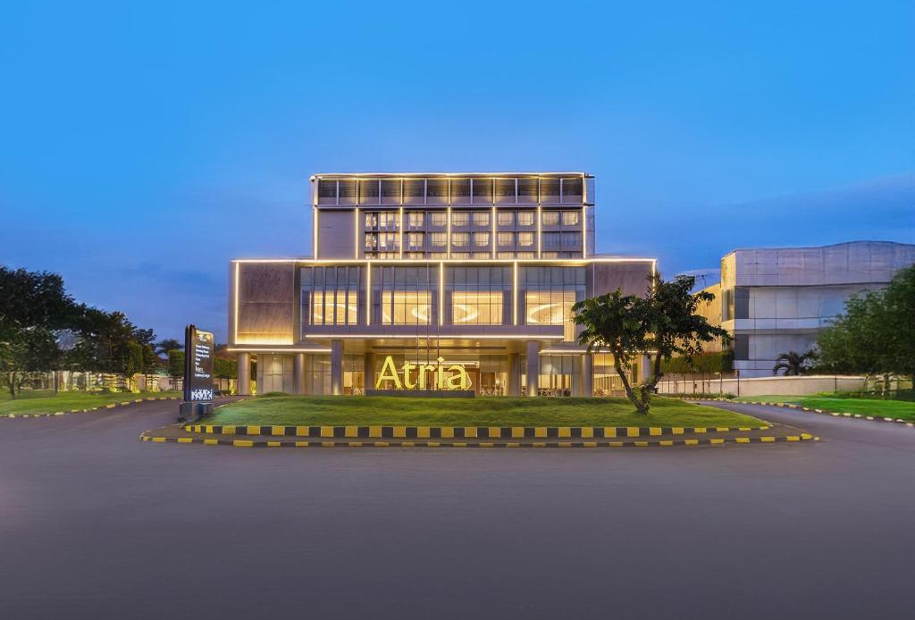 an office building with a sign in front of it at Atria Hotel Malang in Malang