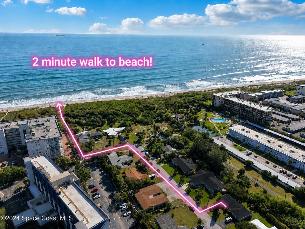 an aerial view of a beach with the words minute walk to beach at Surf Drive - Ultimate Beach Getaway for Families in Cocoa Beach