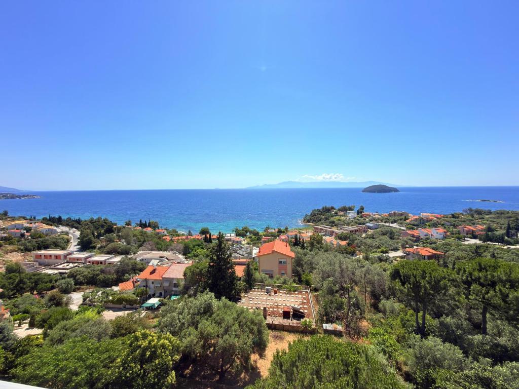 an aerial view of a town and the ocean at Mega Panorama Apartments in Paleo Tsifliki