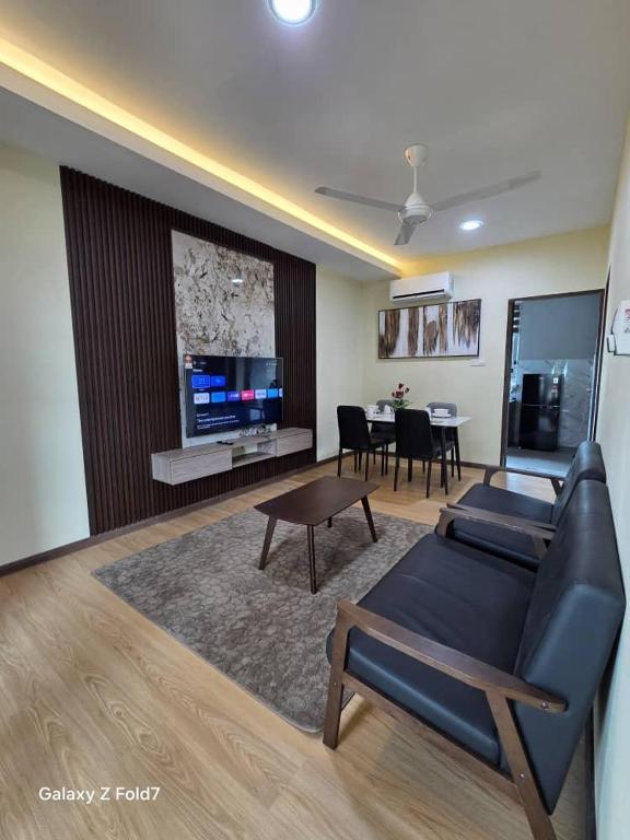 a living room with a couch and a dining room at PJ Luxury Homestay in Sipitang