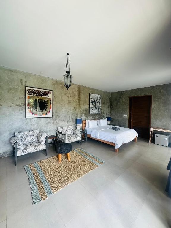 a bedroom with a bed and furniture in a room at The balangan studio room 7 in Bingin Beach