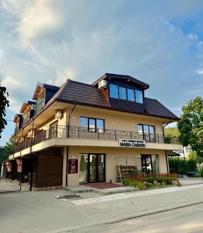 a large building with a balcony on a street at Maria Garden in Kranevo