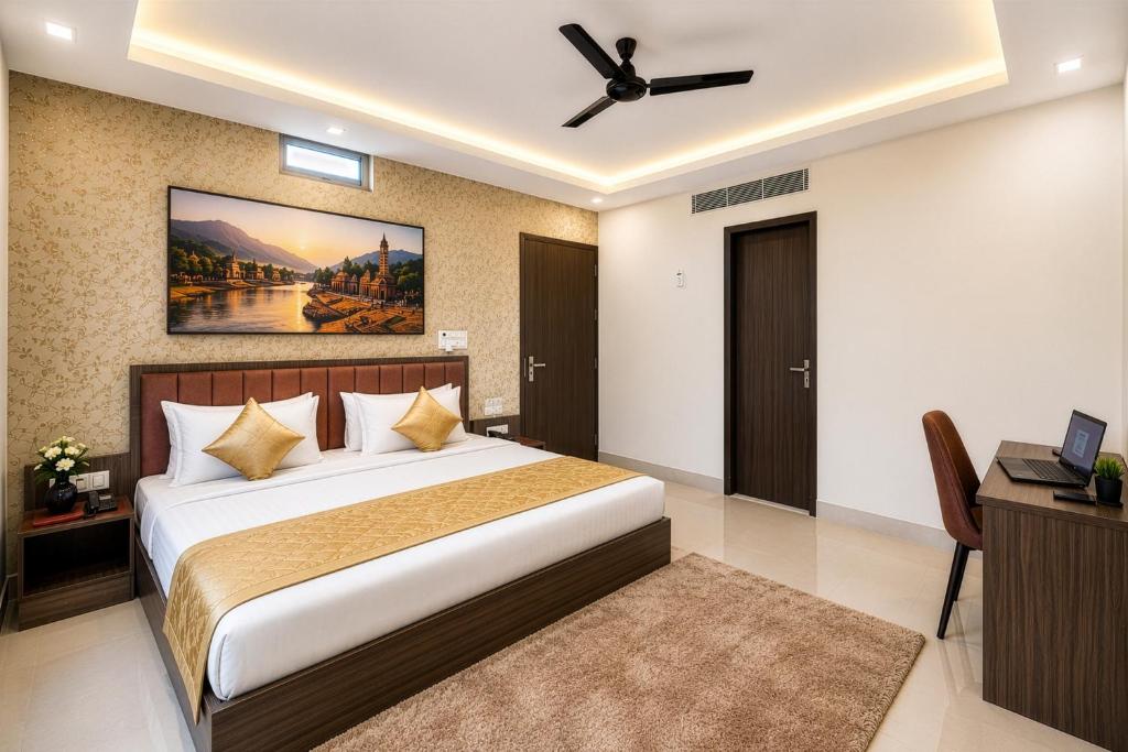 a bedroom with a large bed with a ceiling fan at Hotel The Heights in Haridwār