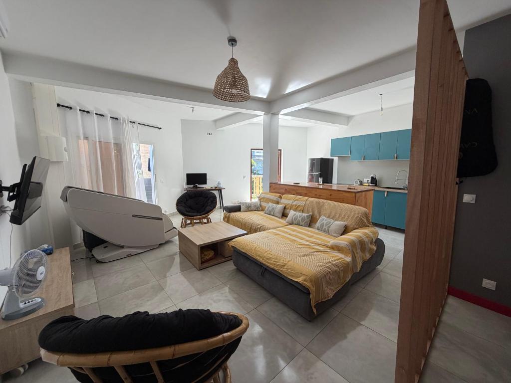 a living room with a couch and a table at Makeda in Chiconi
