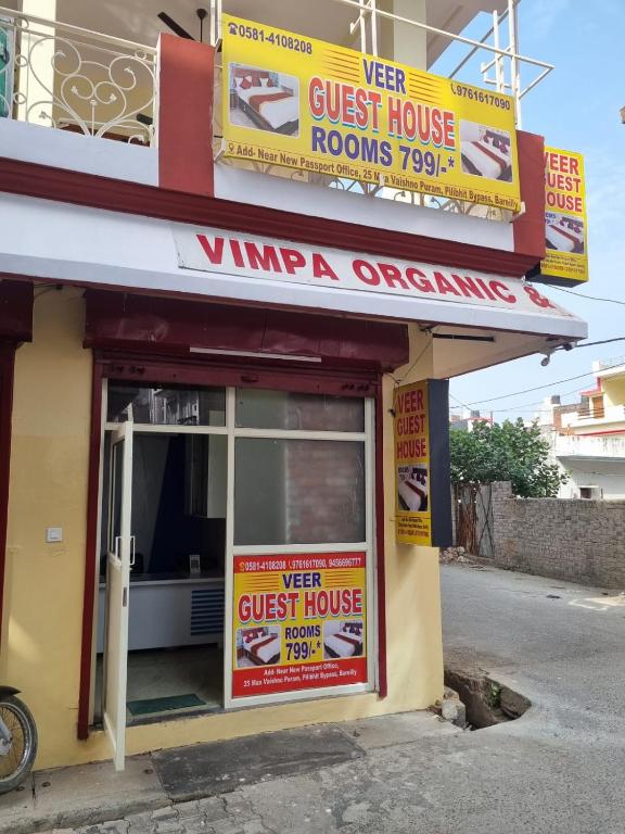 a store with signs on the front of a building at Veer Guest House in Bareilly