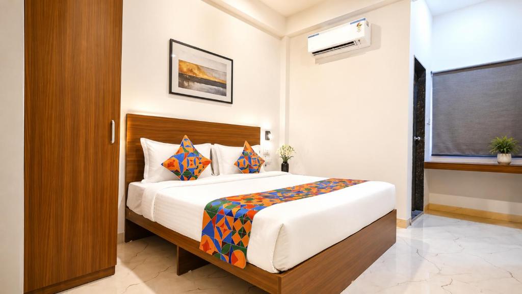 a bedroom with a large bed in a room at Hotel Evanka Brilliant Convention in Indore